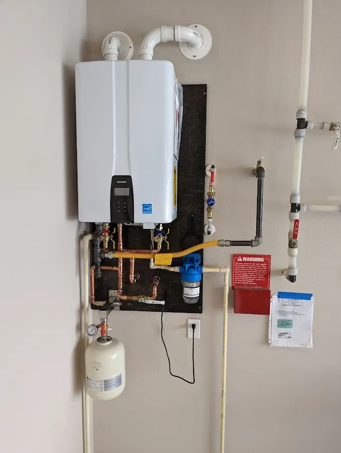 Professional plumber installing copper piping in a Ligonier home